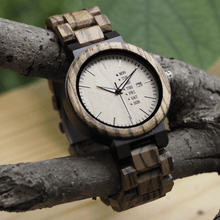 Load image into Gallery viewer, Zebrawood, ebony, and maple wooden watch on a branch
