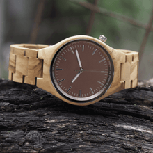 Load image into Gallery viewer, Zebrawood wooden watch laying on branch
