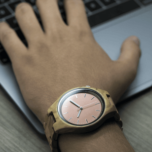 Person wearing wooden watch while working on computer
