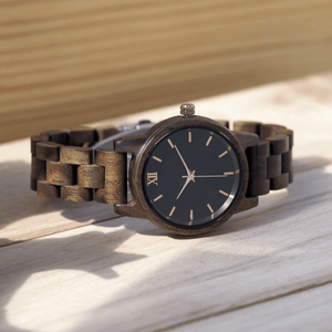 Walnut wooden watch laying on its side